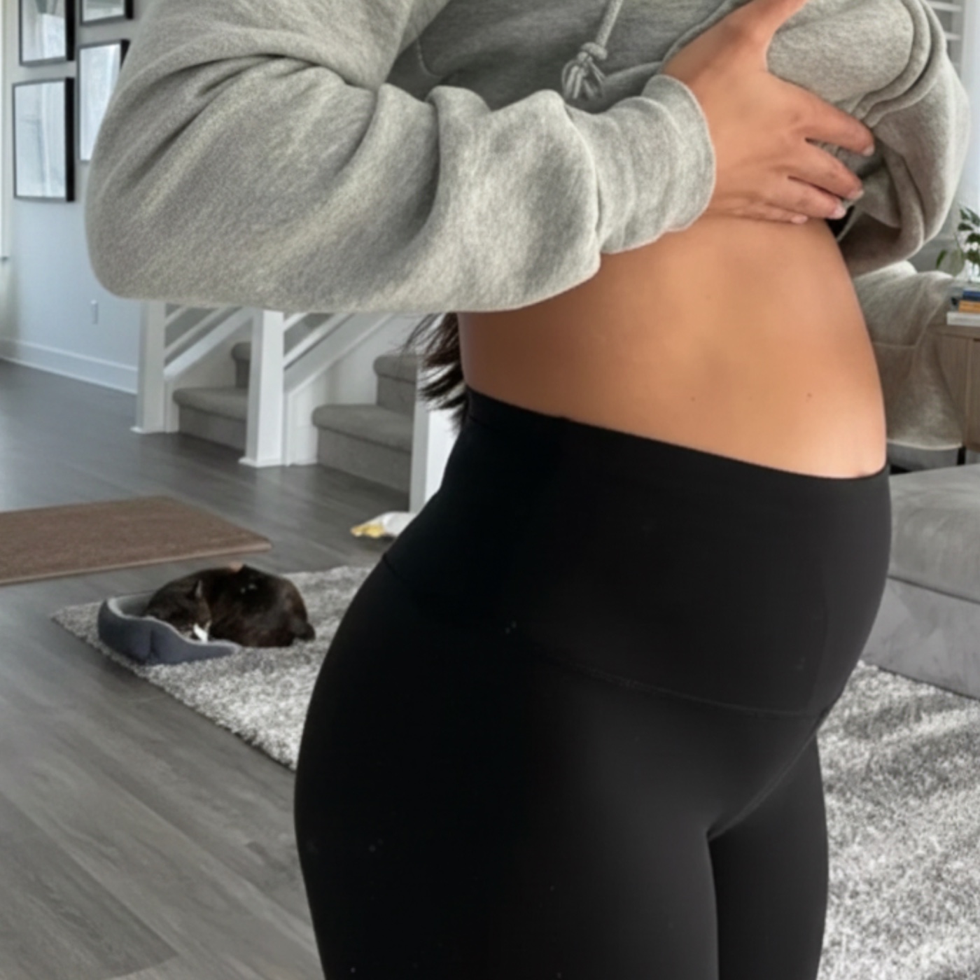 Woman holding her stomach while experiencing bloating