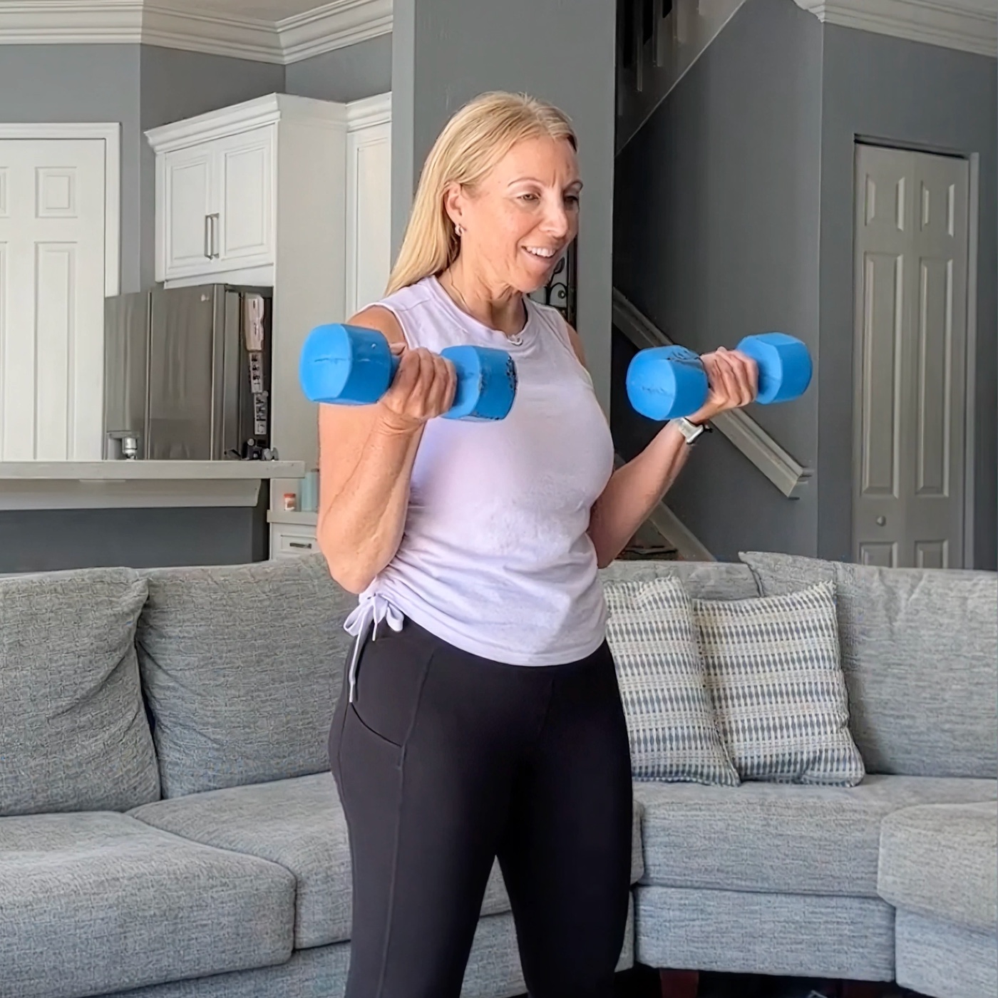 Woman exercising with dumbbells for steady energy